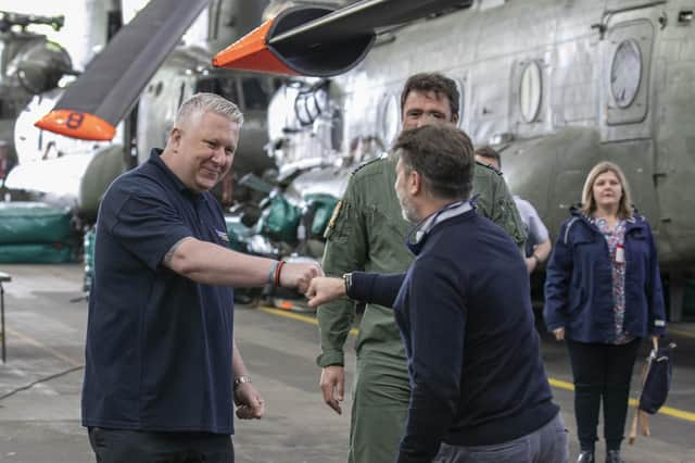 Mick McConnell (left) greets the crew