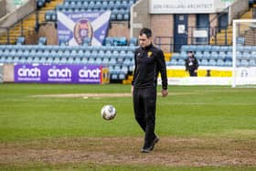 Referee Don Robertson inspects the Dens Park pitch ahead of calling off Dundee v Rangers. (Photo by Alan Harvey / SNS Group)
