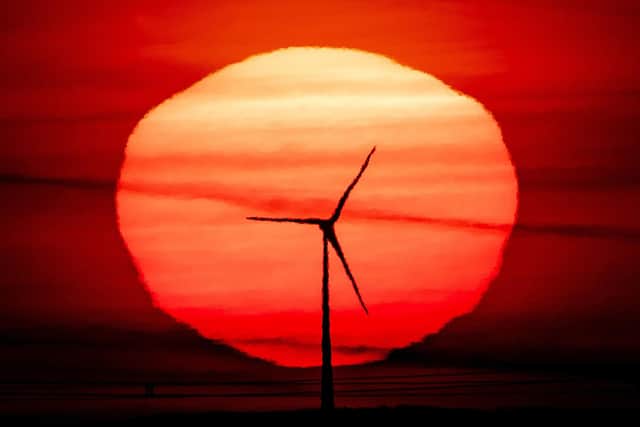 The sun rises behind a wind turbine. Up to 80 jobs will be made redundant at SGL Carbon, which makes the material used for wind turbines, amid a downturn in the sector. Picture: AP Photo/Michael Probst