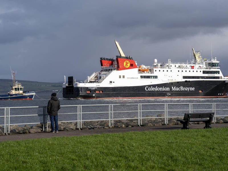 An onlooker watches on as the Glen Sannox undergoes a sea trial, accompanied by tugs, on a short trip under her own propulsion from Ferguson Marine yard in Port Glasgow, Inverclyde. Picture: Jane Barlow/PA Wire