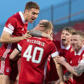 Aberdeen players celebrate their penalty shootout victory over Livingston after scoring with all five efforts from the spot (Photo by Ross Parker / SNS Group)