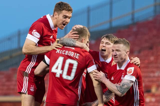 Aberdeen players celebrate their penalty shootout victory over Livingston after scoring with all five efforts from the spot (Photo by Ross Parker / SNS Group)