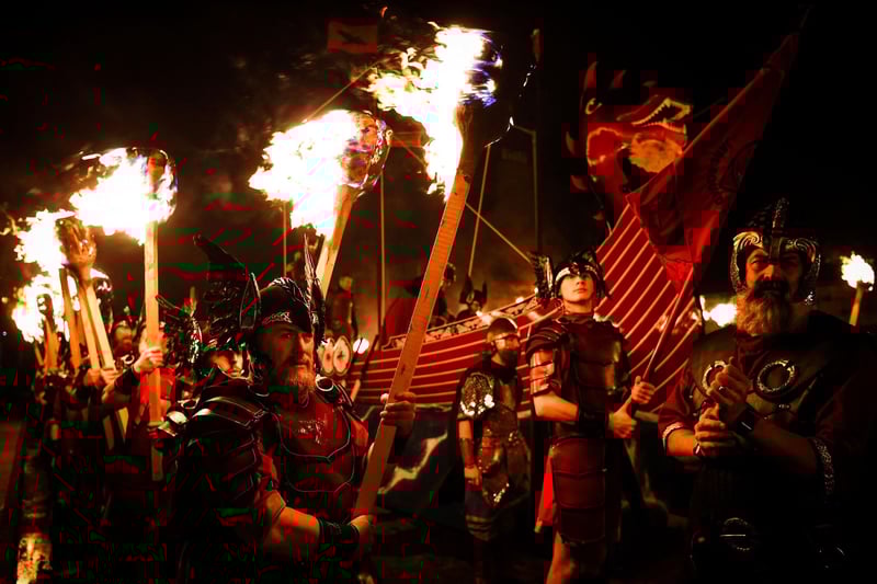 The event, which attracts visitors from around the globe, sees people dressed as Vikings march through the streets of Lerwick to recreate its ancient Viking past, in a tradition dating back to the 19th century.
(Photo by Andy Buchanan / AFP)