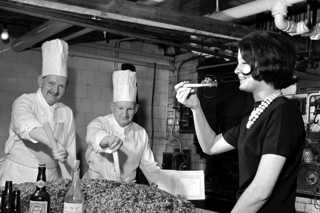 340lb Christmas pudding being mixed by Pastry chef Danny Morton (left) with second chef William Milne at the Caledonian Hotel, Edinburgh. Tested by receptionist Olivia Renylel.