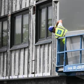 Workers remove cladding for testing from a tower block in the wake of the Grenfell Tower tragedy. Picture: Christopher Furlong/Getty Images