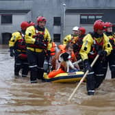 Members of the coastguard rescue team wade through flood waters to evacuate a man and a dog in Brechin on October 20 after areas close to the river were overwhelmed by water which breached flood defences. Picture: Jeff J Mitchell/Getty Images