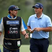 Patrick Reed speaks with his caddie during the opening round of the Hero Dubai Desert Classic at Emirates Golf Club. Picture: Warren Little/Getty Images.