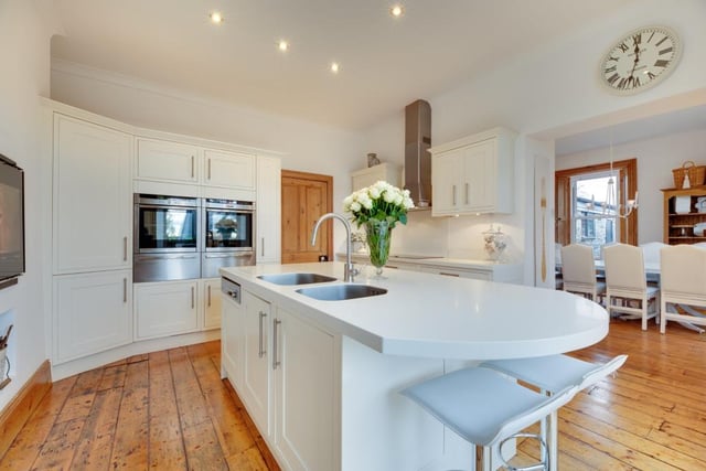 The stylish kitchen offers a central island with breakfast bar.