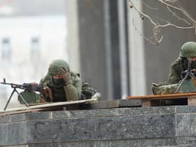 Soldiers without identifying insignia outside the Crimean parliament building in Simferopol, Ukraine, in 2014, shortly before Russia annexed the region (Picture: Sean Gallup/Getty Images)