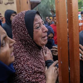 People mourn in Khan Yunis as they wait on Christmas Day to collect the bodies of friends and relatives killed in an airstrike  in  Gaza late on Sunday night.  (Photo by Ahmad Hasaballah/Getty Images)