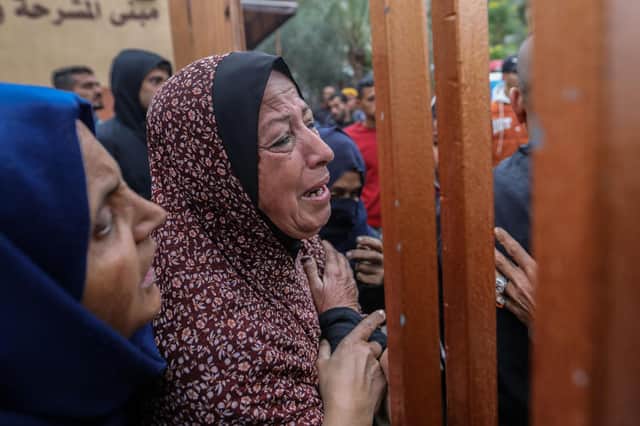 People mourn in Khan Yunis as they wait on Christmas Day to collect the bodies of friends and relatives killed in an airstrike  in  Gaza late on Sunday night.  (Photo by Ahmad Hasaballah/Getty Images)