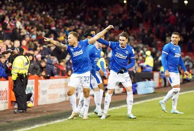 Scott Arfield leads the celebrations with the Rangers fans after scoring a 97th-minute winner at Pittodrie.
