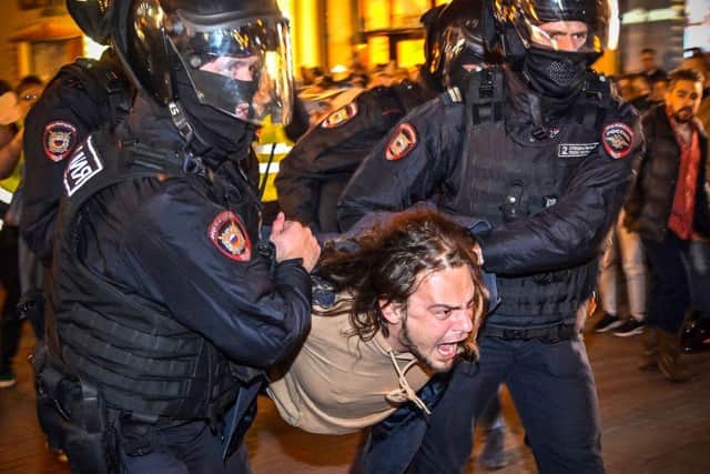 Police officers detain a man following calls to protest against partial mobilisation announced by Russian President, in Moscow on Wednesday.