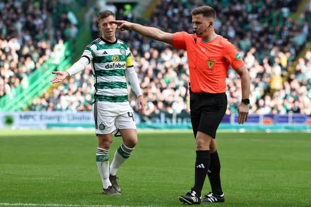Referee Grant Irvine points to the spot to award Celtic a penalty following a VAR check.