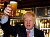 Another Conservative MP has called for Boris Johnson to resign as it is understood the Met Police have a picture of Mr Johnson holding a pint at a lockdown party.