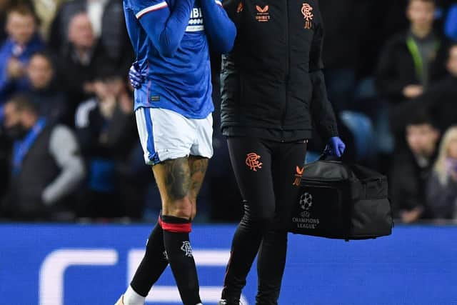 Rangers' Connor Goldson leaves the field in pain after picking up an injury.
