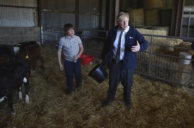 The failures of Boris Johnson, seen feeding cattle at Moor Farm in Stoney Middleton, England, while campaigning ahead of the English council elections, let the SNP off the hook, says Anas Sarwar (Picture: Rui Vieira/AP)