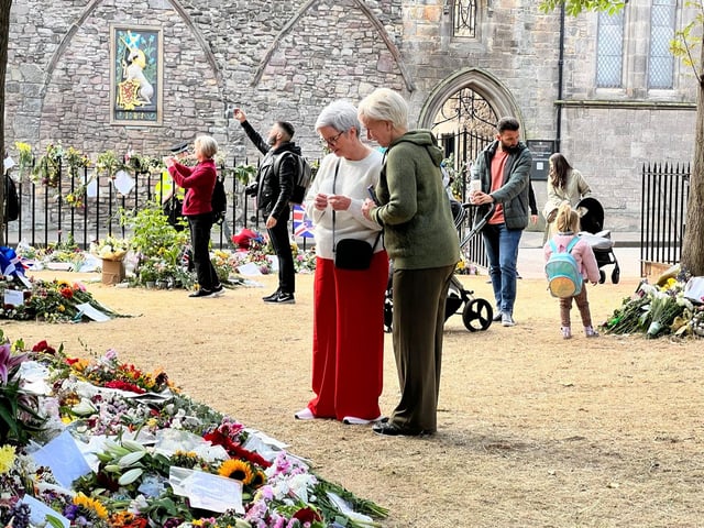 People have been leaving flowers and messages at the palace in Edinburgh.