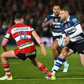 Finn Russell of Bath takes on Seb Atkinson of Gloucester during the Gallagher Premiership encounter.