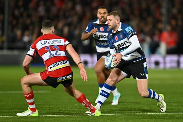 Finn Russell of Bath takes on Seb Atkinson of Gloucester during the Gallagher Premiership encounter.