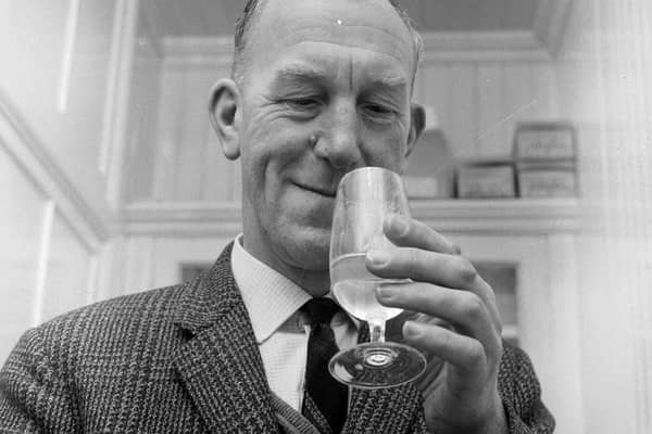 Glenlivet Distillery manager Robert Arthur enjoys a little quality control - by tasting a dram of whisky.