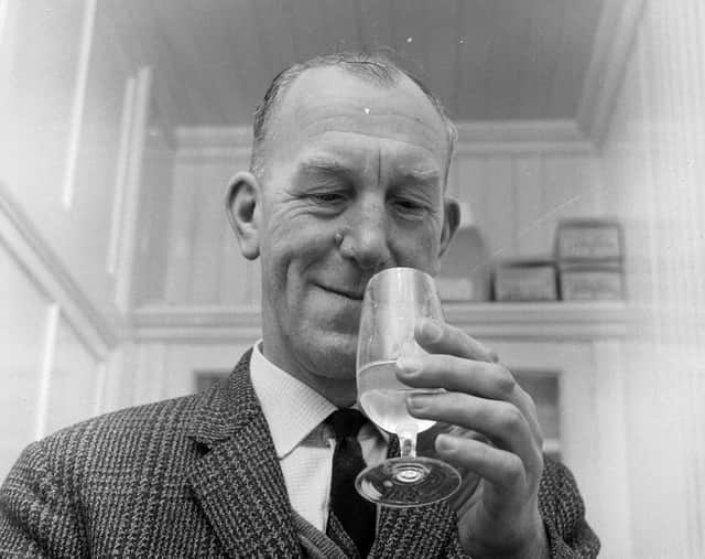 Glenlivet Distillery manager Robert Arthur enjoys a little quality control - by tasting a dram of whisky.