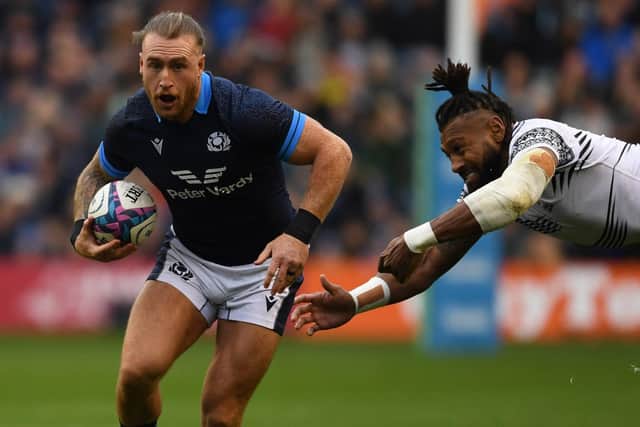 Scotland's Stuart Hogg evades Fiji's Waisea Nayacalevu. (Photo by Ross MacDonald / SNS Group)
