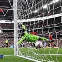 Ellis Simms of Coventry City scores his team's first goal past Andre Onana.