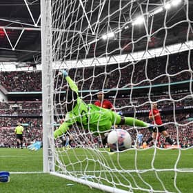 Ellis Simms of Coventry City scores his team's first goal past Andre Onana.