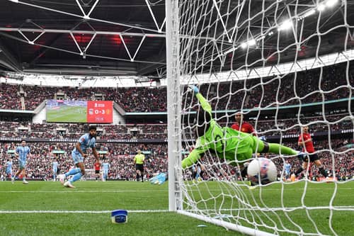 Ellis Simms of Coventry City scores his team's first goal past Andre Onana.