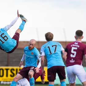Hearts midfielder Andy Halliday rises above the rest as team-mate Liam Boyce holds off the Arbroath players.