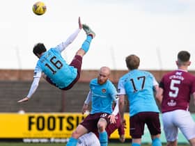 Hearts midfielder Andy Halliday rises above the rest as team-mate Liam Boyce holds off the Arbroath players.