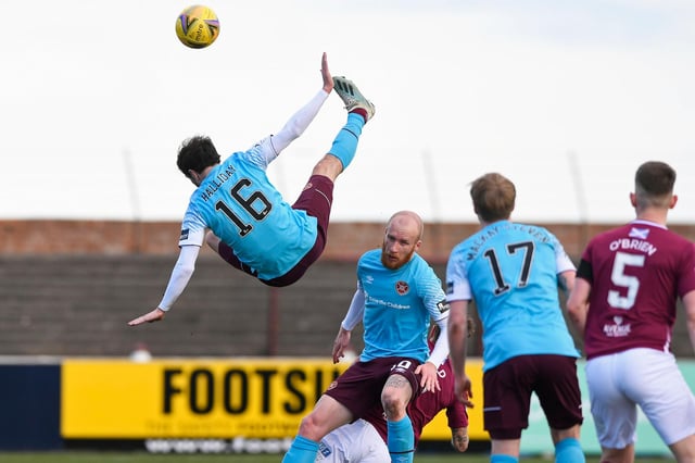 Hearts midfielder Andy Halliday rises above the rest as team-mate Liam Boyce holds off the Arbroath players.