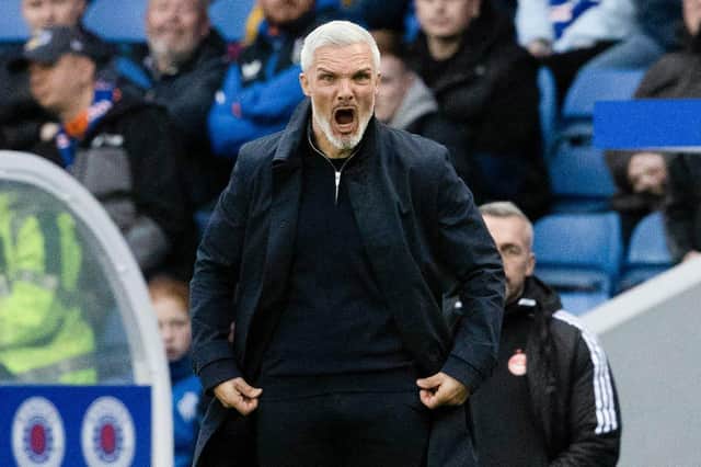 Aberdeen manager Jim Goodwin shouts from the touchline.