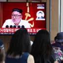 People watch a television broadcast showing a file image of North Korean leader Kim Jong-Un at his government's attempt to launch a spy satellite last month.