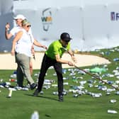 Groundskeepers sweep up bottles and cans thrown from the stands on the 16th hole after a hole-in-one by Sam Ryder during the third round of the WM Phoenix Open at TPC Scottsdale Arizona. Picture: Mike Mulholland/Getty Images.