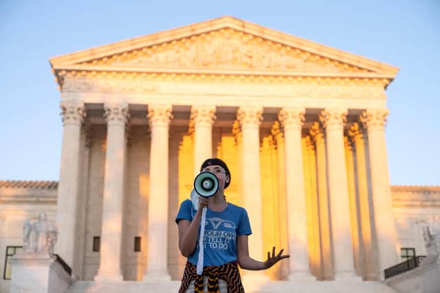 An activist, who declined to provide her name, speaks outside the US Supreme Court in protest against a new Texas abortion law that prohibits the procedure after six weeks into a pregnancy (Picture: Drew Angerer/Getty Images)