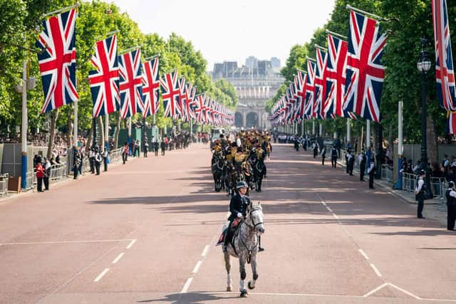 A mounted police officer rides in front of members of the Kings Troop Royal Horse Artillery during the Queen's Birthday Parade, the Trooping the Colour, as part of Queen Elizabeth II's platinum jubilee celebrations, in London. Picture: Aaron Chown/POOL/AFP via Getty Images