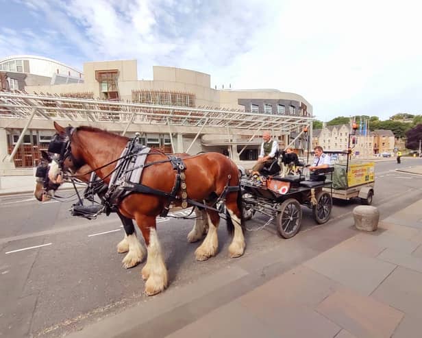 Mr Alcock passes the Scottish parliament during the charity challenge