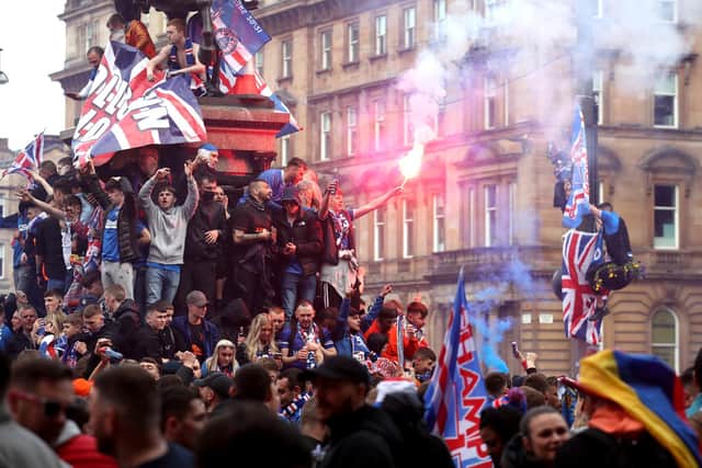 Rangers fans celebrate winning the Scottish Premiership in George Square, Glasgow, after their match against Aberdeen.