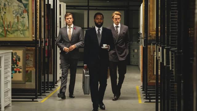 John David Washington (centre) plays the film's unnamed protagonist