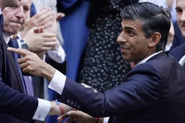 Rishi Sunak gestures as conservative MPs greet him after arriving at the Conservative Party leadership contest at the Conservative party Headquarters in London. Picture: AP Photo/Aberto Pezzali