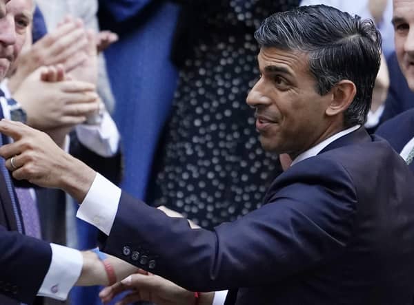 Rishi Sunak gestures as conservative MPs greet him after arriving at the Conservative Party leadership contest at the Conservative party Headquarters in London. Picture: AP Photo/Aberto Pezzali