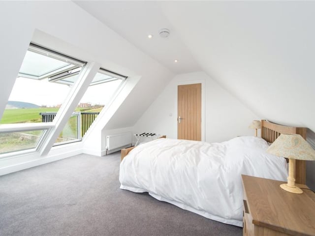 Bedroom 4 has built in storage and bi-fold Velux windows which open onto a balcony.