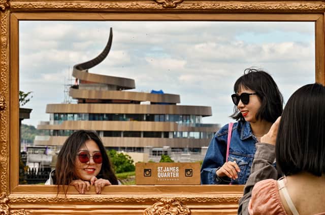 Members of the public are pictured in a frame with a view of the newly built W Edinburgh hotel - also known as Ribbon Hotel - from Calton Hill. Maybe if you're young and a tourist you might like it. Those of us born here, some years ago, may disagree, writes Aidan Smith.