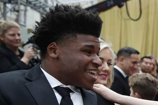 Jerry Harris talks to an actress on the red carpet at the Oscars at the Dolby Theatre in Los Angeles, Feb. 9, 2020. A federal judge Wednesday, July 6, 2022, sentenced Harris, a former star of the Netflix documentary series Cheer to 12 years in prison for coercing teenage boys to send him obscene photos and videos of themselves and soliciting sex from minors at cheerleading competitions.  (AP Photo/John Locher File)