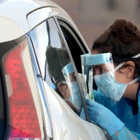 A nurse prepares to take a sample at a COVID 19 testing centre in the car park of the Bowhouse Community Centre in Grangemouth