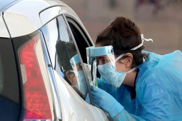 A nurse prepares to take a sample at a COVID 19 testing centre in the car park of the Bowhouse Community Centre in Grangemouth
