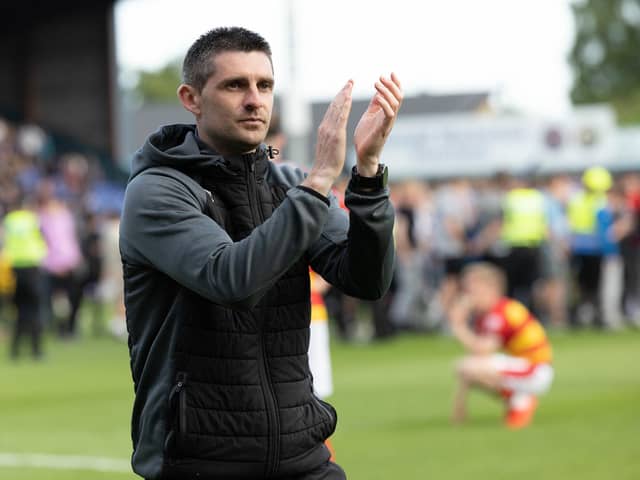 Kris Doolan applauds the Partick Thistle support after they lost the Premiership play-off on penalties. (Photo by Ross Parker / SNS Group)
