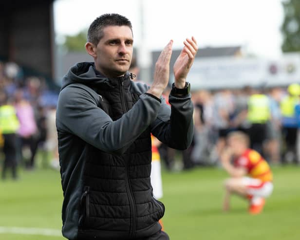 Kris Doolan applauds the Partick Thistle support after they lost the Premiership play-off on penalties. (Photo by Ross Parker / SNS Group)